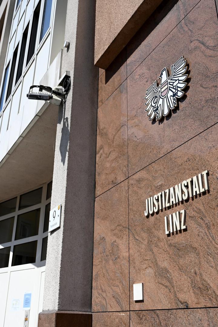 Die Justizanstalt Linz mit Bundesadler an einer Fassade aus braunem Marmor.