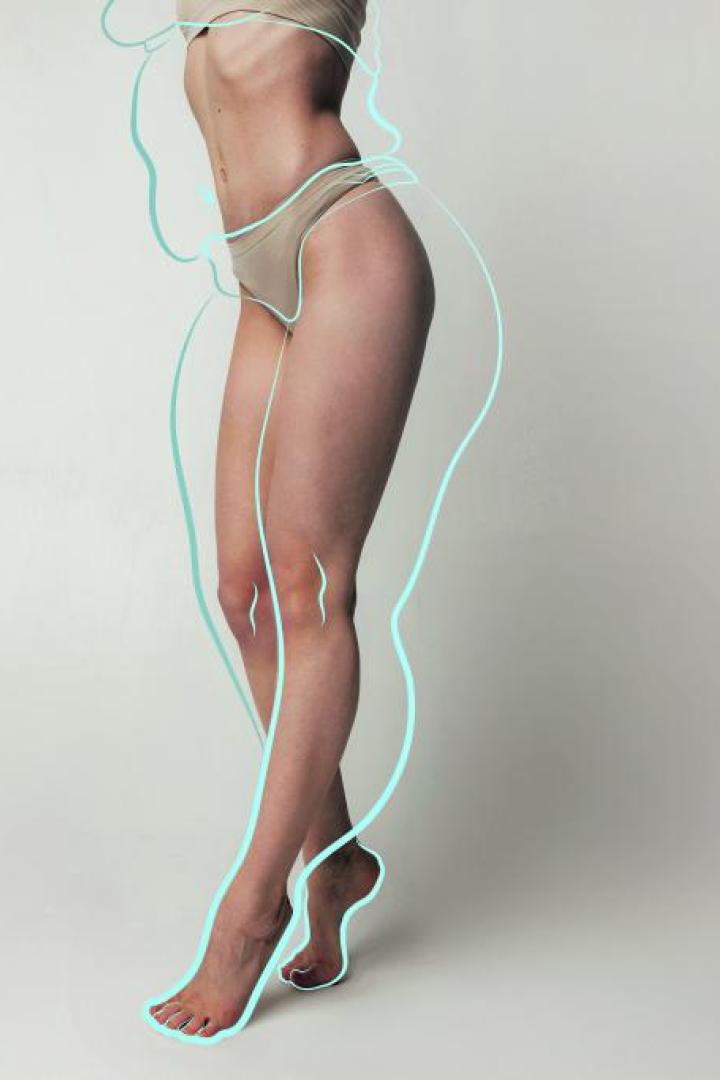 Cropped tender woman body in beige lingerie with drawn blue silhouette around body posing over studio background. body positivity