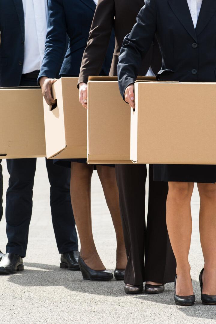 Businesspeople With Cardboard Boxes Standing In A Line