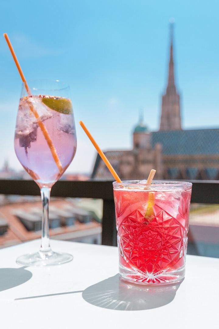 Two glasses of cocktails on a table in bar terrace with observation deck