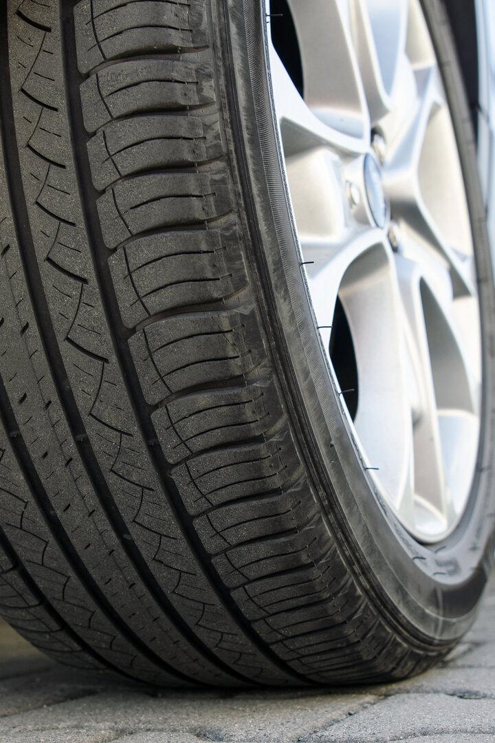 Car tire close up, parked car low angle shot