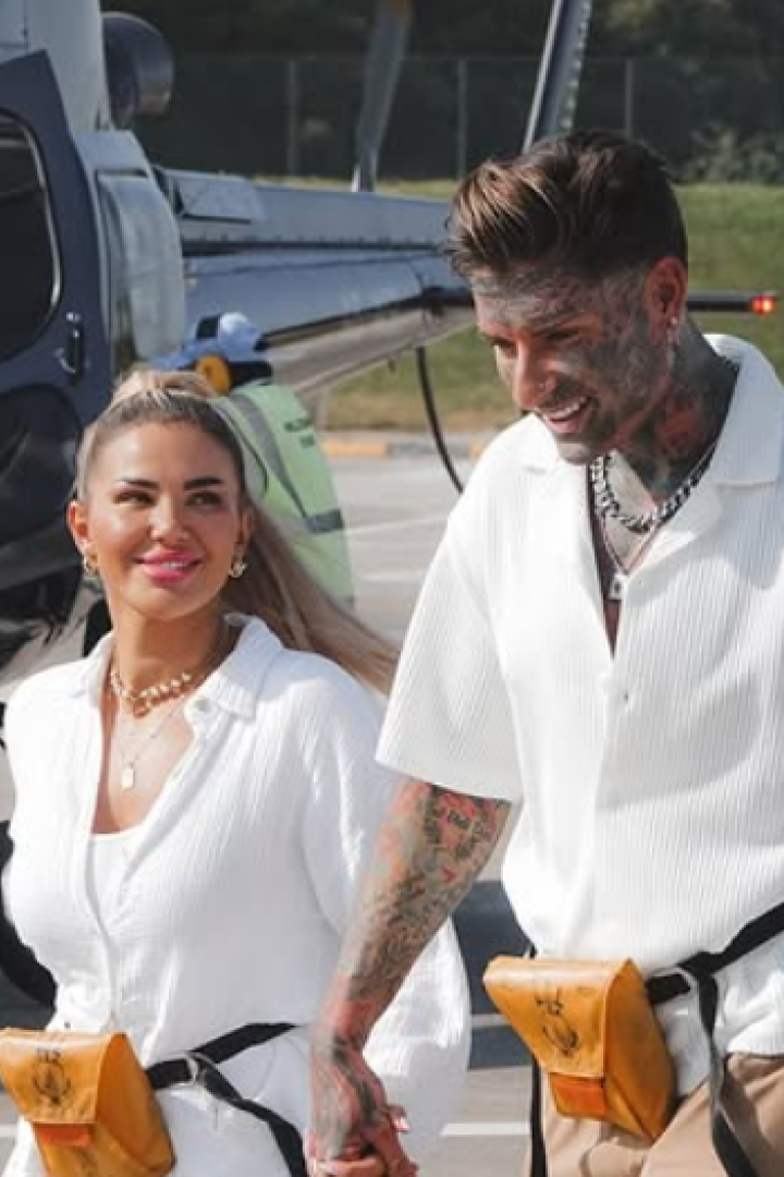 Kim Virginia und Nikola Glumac gehen Hand in Hand vor einem Helikopter