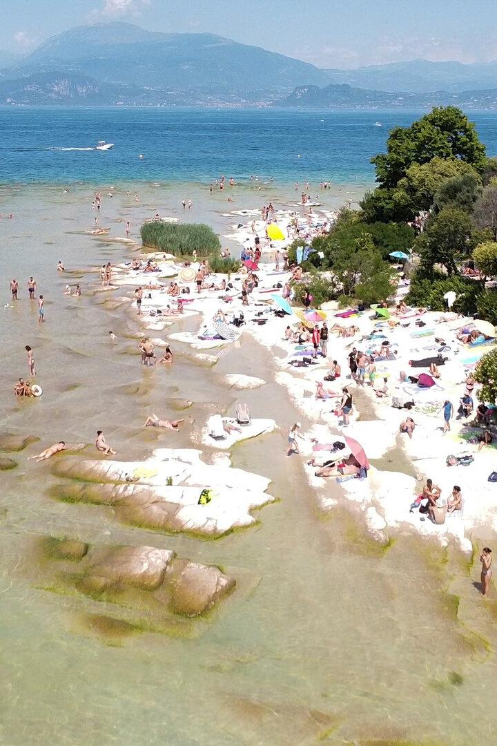 People flock to one of the beaches of Lake Garda, in southern Sirmione Peninsula