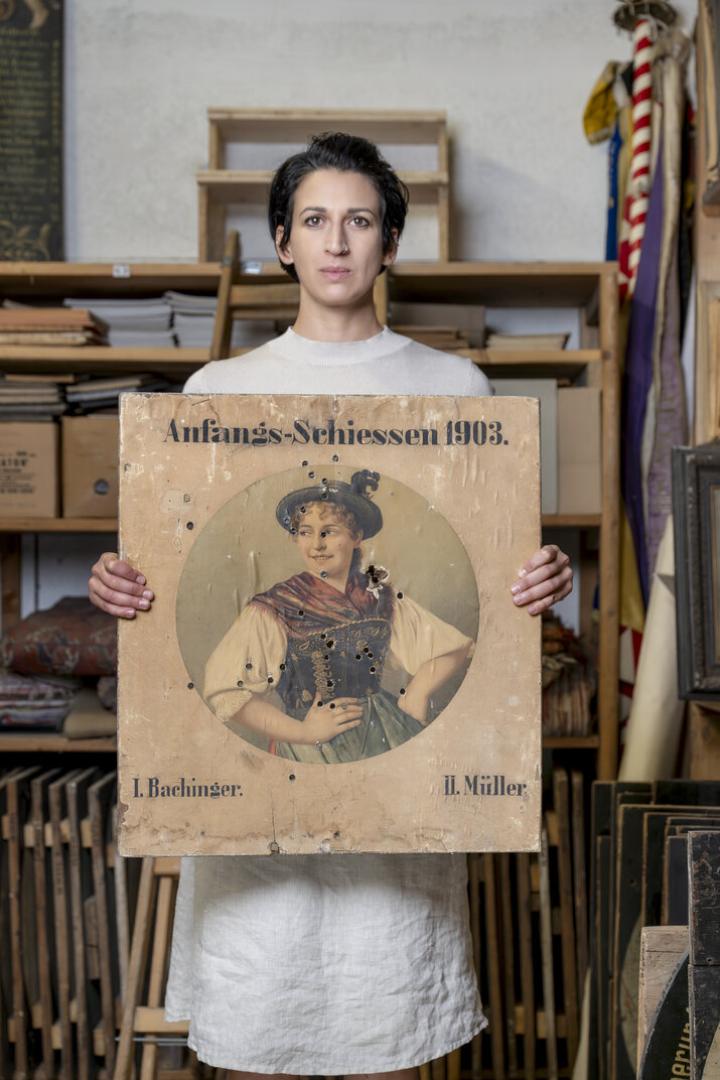 Frau hält Schießscheibe in die Luft