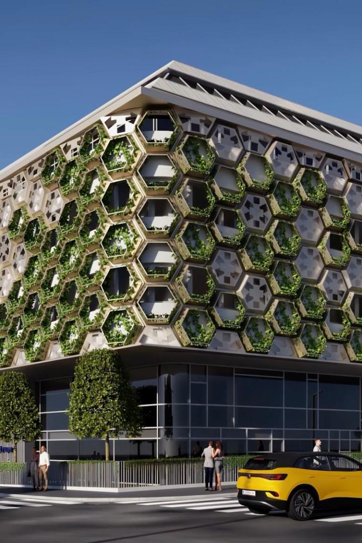 Ein Rendering des neuen Gesundheitszentrums mit grüner Fassade. 