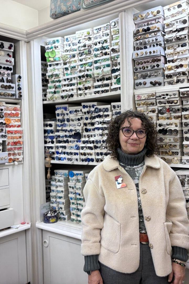 Martina Schrutka steht in ihrem Geschäft vor einer Wand voller Knöpfe.