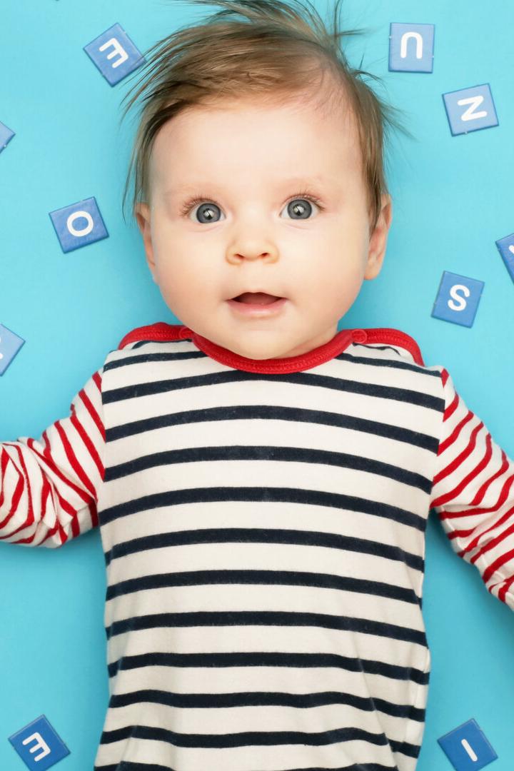 Portrait of adorable 3 months old baby on the blue background, studio shot