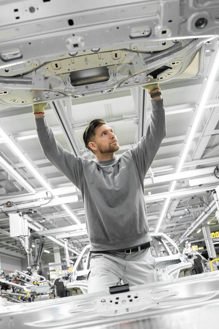 Fabrikarbeiter begutachtet ein Bauteil für den Porsche Cayenne Elektrik in der VW-Fabrik bei Bratislava.