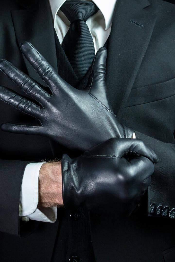 Mafia Hit Man Pulling on Leather Gloves