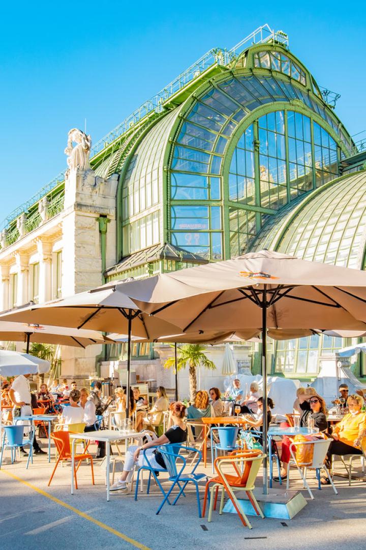 Summer street cafe in Vienna old town, Butterfly House (Schmetterlinghaus) on background