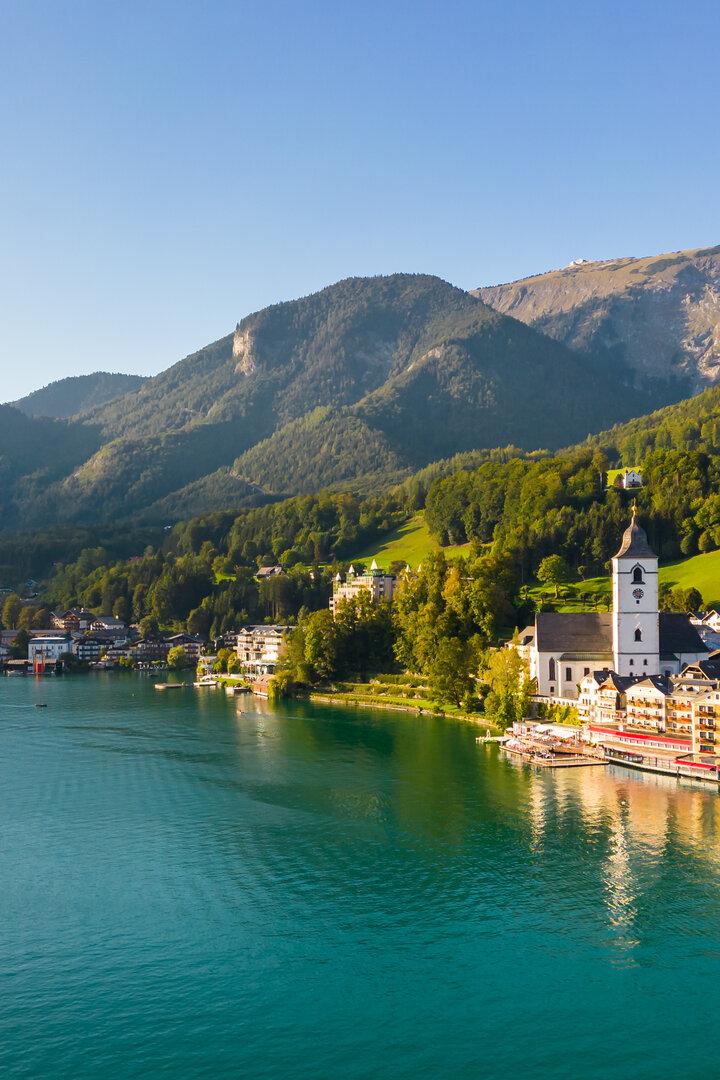 Beautiful aerial view of the popular village of Sankt Wolfgang im Salzkammergut. Alpine mountains, church and Wolfgangsee. Upper Austria, Salzburg.