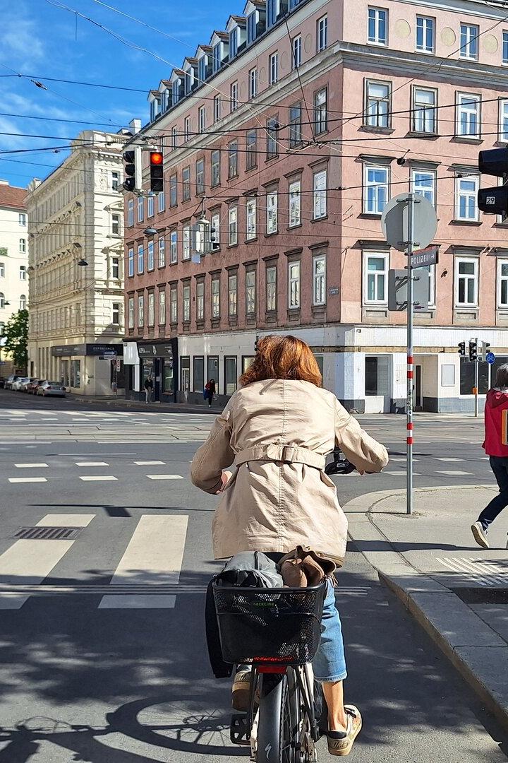 Radfahrerin wartet vor roter Ampel.