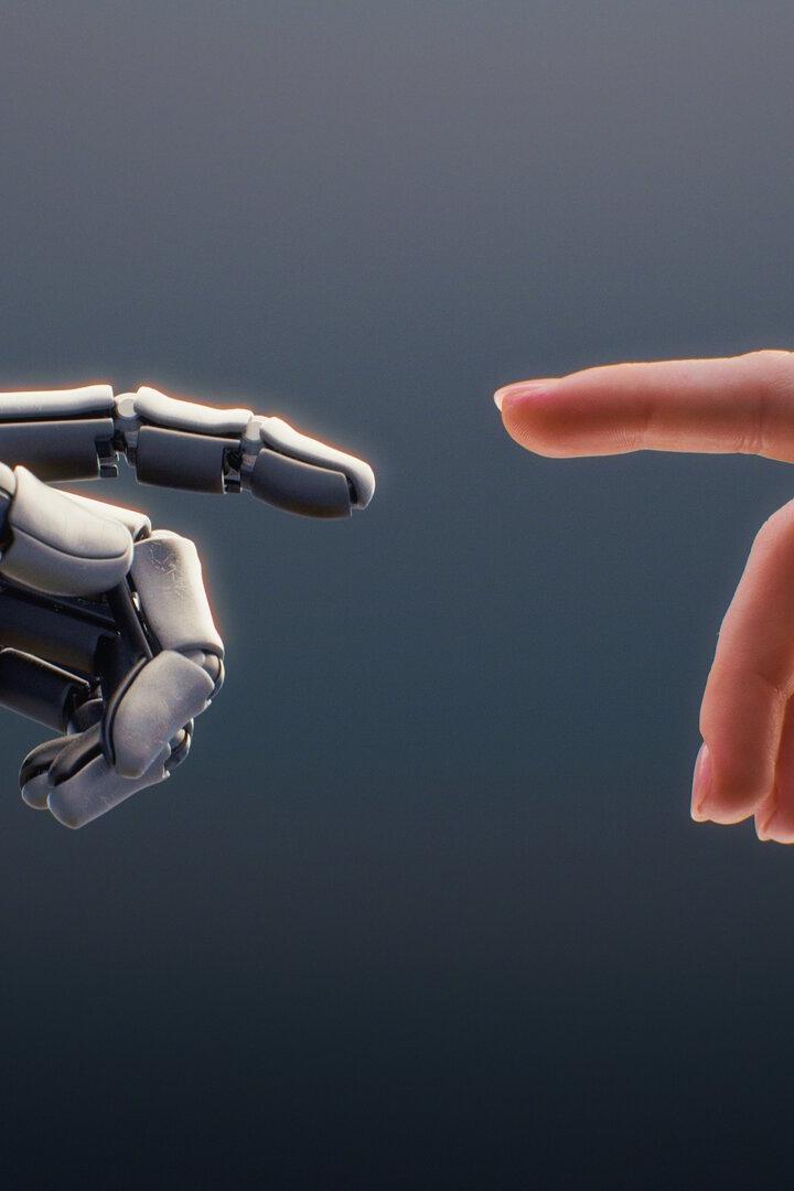 Eine menschliche Hand und eine Roboterhand nähern sich einander mit ausgestreckten Zeigefingern.
