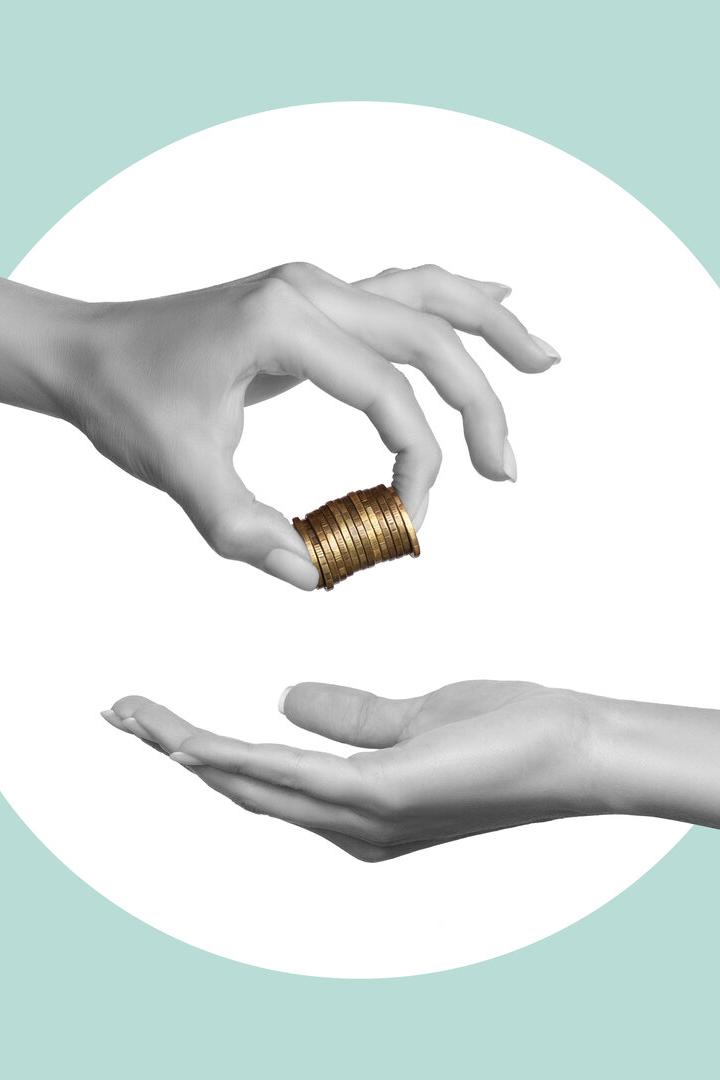 A woman's hand holds coins and hands them to a man