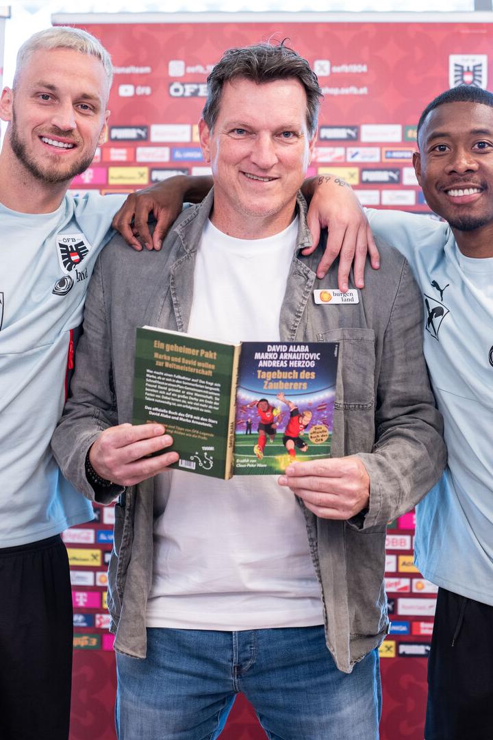 Andreas Herzog posiert mit Marko Arnautovic, David Alaba und Kinderbuch.