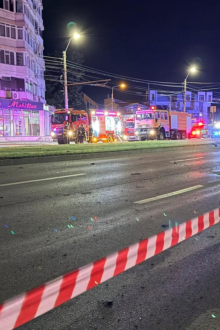 Firefighters and law enforcement work on the site of an explosion at a residential block of flats following a drone hit close to the border with Ukraine