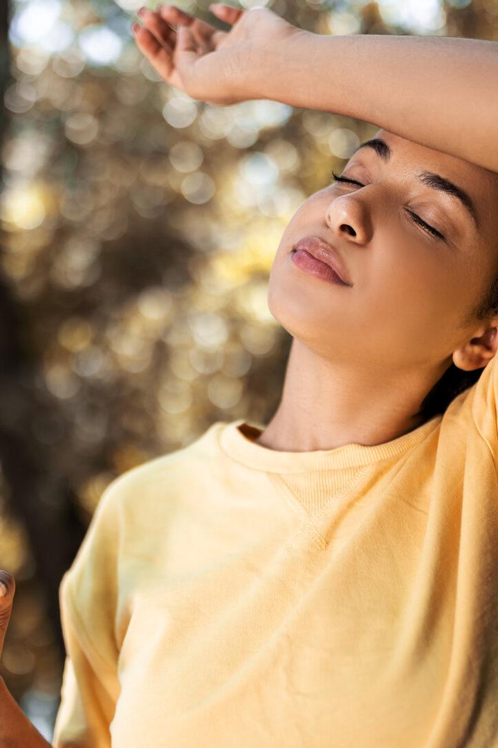 Young woman drinking water taking a break