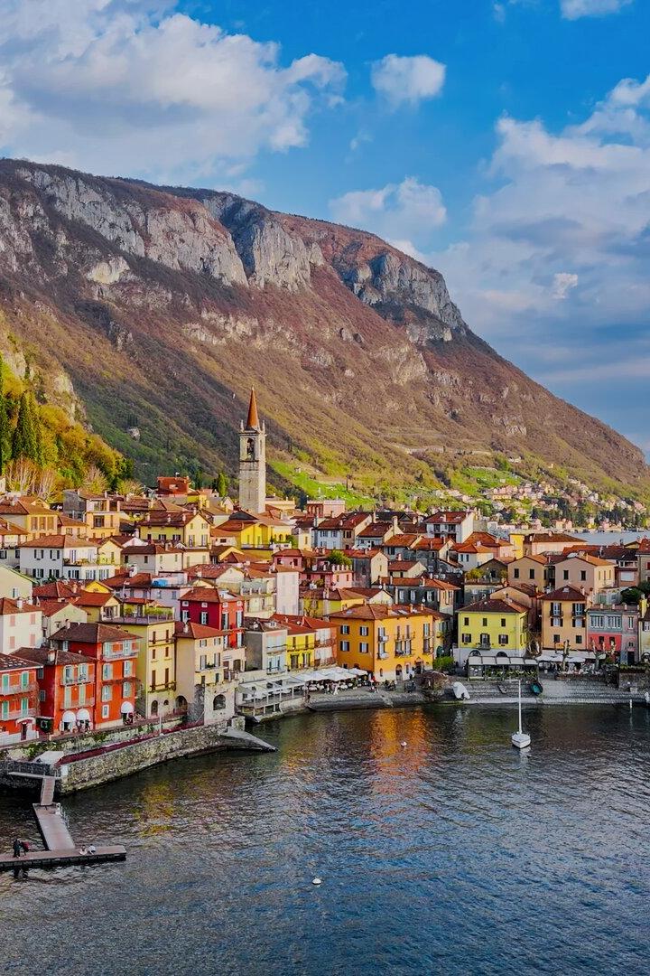 Aerial view of the colorful village of Varenna on the eastern shore of Lake Como with church tower, mountain landscape, and waterfront promenade, Traditional architecture and travel concept in Lombardy, Northern Italy