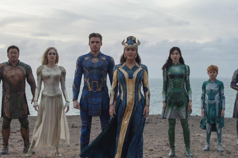 Die Gruppe der Eternals steht am Strand vor dem Meer.
