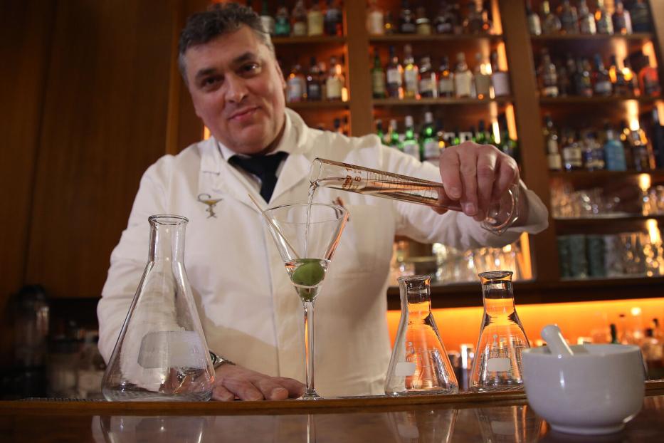 Heinz Kaiser mixt einen Drink mit Messzylinder und Laborgläsern.
