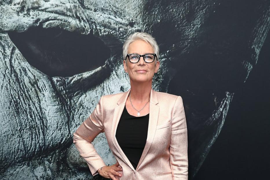 Jamie Lee Curtis posiert vor einem Poster für den Film „Halloween“.