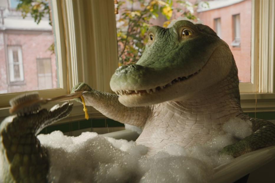 Ein animiertes Krokodil sitzt in einer Badewanne voller Schaum und putzt sich die Zähne.