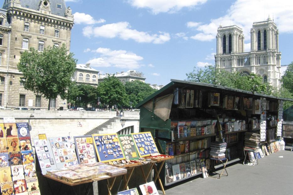 Ein Bücherstand an der Seine in Paris mit Blick auf Notre-Dame.