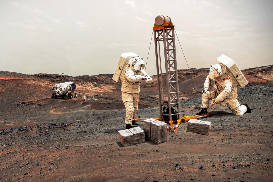 Astronauten platzieren auf dem kargen Boden Ausrüstung. So sah es ein künstlerisches Konzept.