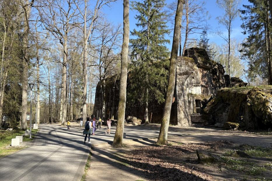 Besucher spazieren an den  Betonruinen der Wolfsschanze in Gierłoż vorbei.