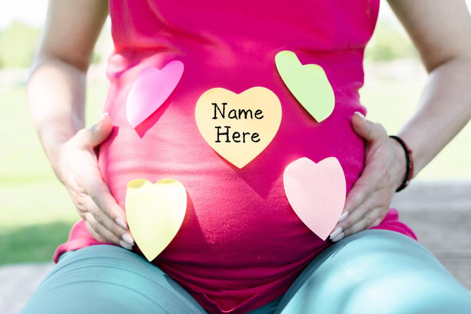 Pregnant woman choosing a name for a baby
