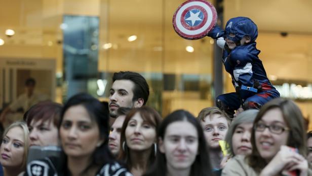 A boy dressed as Captain America awaits the start Siegeszug der Comics: Wir sind Helden