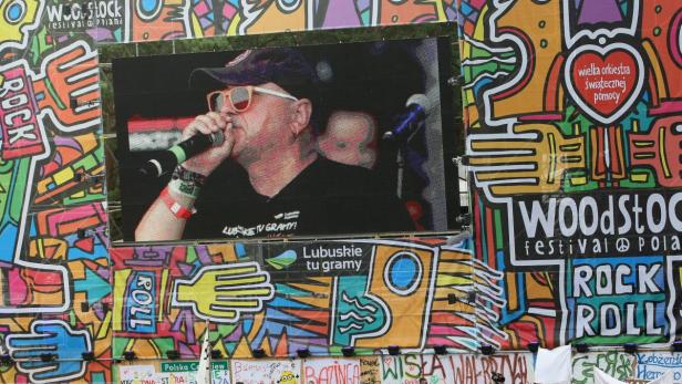 Ein Sänger mit Sonnenbrille tritt auf einer großen Leinwand beim Woodstock Festival Polen auf.