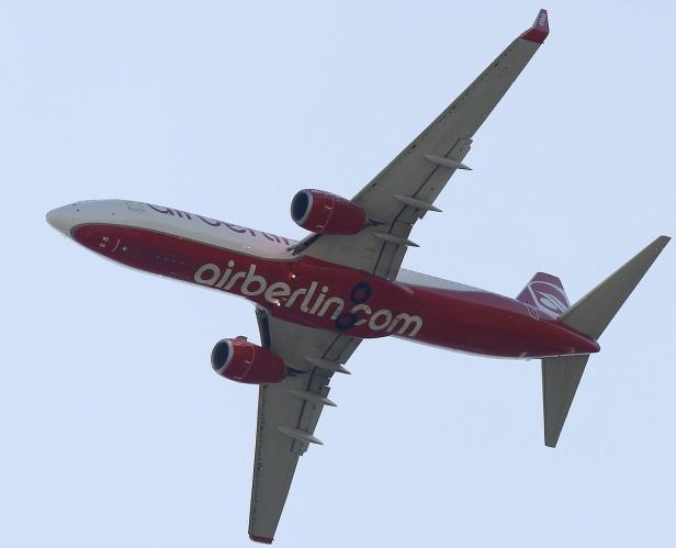 Ein rot-weißes Flugzeug von Air Berlin steigt in den Himmel auf.