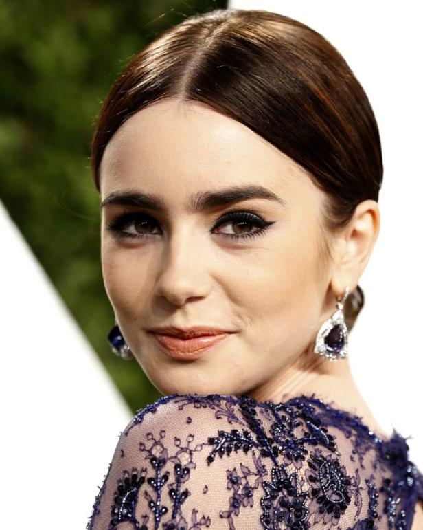 Ein Porträt von Lily Collins mit dunklem Haar und blauem Kleid.