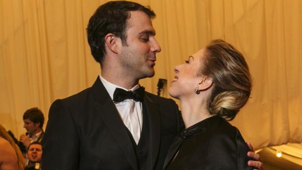Ein Mann im Smoking und eine Frau in Abendgarderobe schauen sich an.