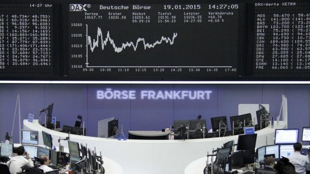 Traders work at their screens in front of the Germ