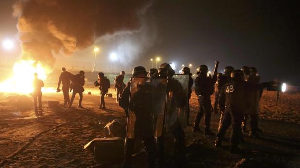 French CRS riot police secure an area on the eve o
