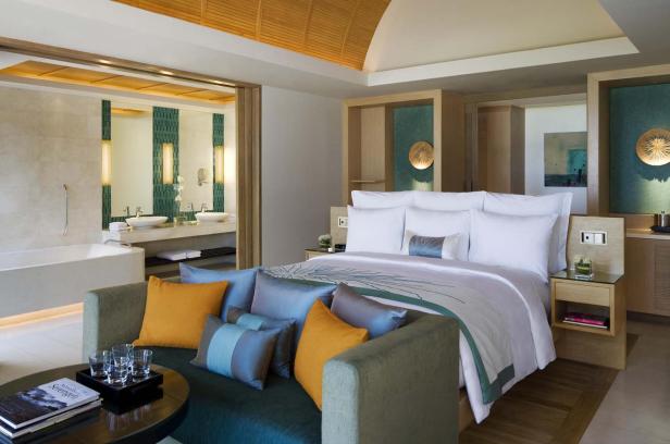 Ein luxuriöses Hotelzimmer mit einem Kingsize-Bett und einem angrenzenden Badezimmer.