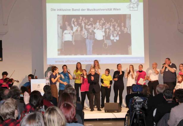 Die inklusive Band der Musikuniversität Wien tritt vor Publikum auf einer Bühne auf.
