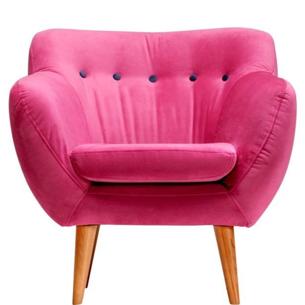 Ein pinkfarbener Sessel mit Holzbeinen vor einem weißen Hintergrund.