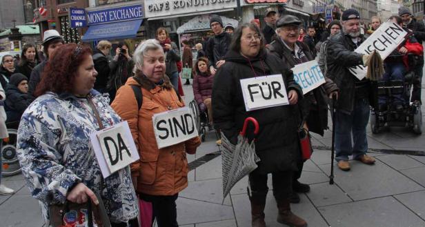 Eine Gruppe von Menschen demonstriert mit Schildern, auf denen „Da sind Rechte für Menschen“ steht.