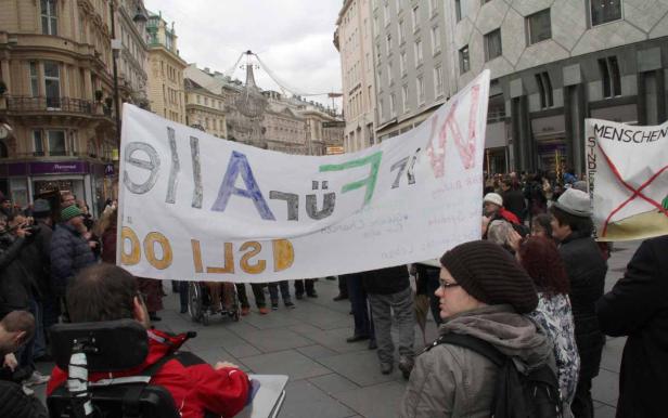 Eine Demonstration mit einem Transparent, auf dem „Alle sind gleich“ steht.