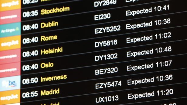 A flight information board is seen at Gatwick Airp