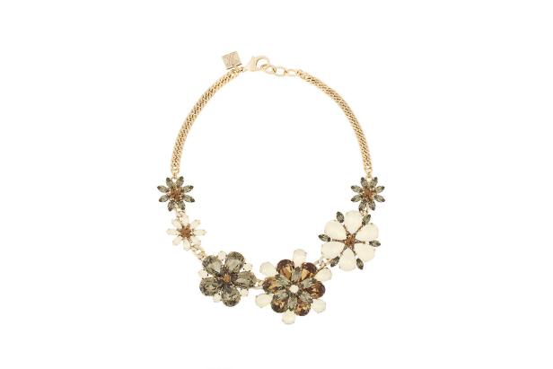 Eine goldene Halskette mit Blumenornamenten aus braunen und weißen Schmucksteinen.