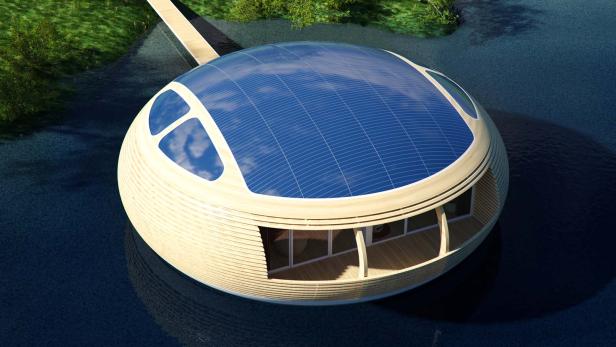 Ein rundes Haus mit Solardach schwimmt auf dem Wasser.