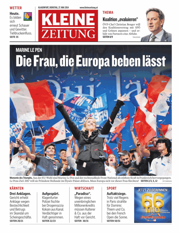 Marine Le Pen feiert mit Anhängern und französischen Flaggen bei einer Wahlveranstaltung.