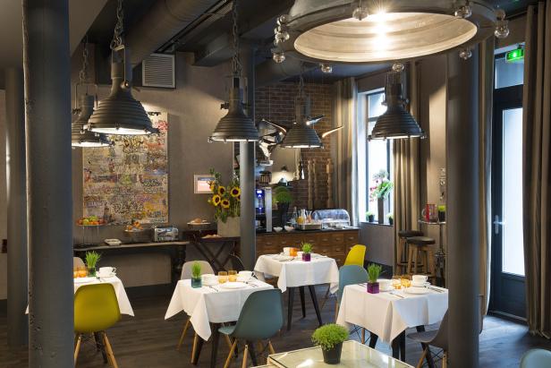 Ein Frühstücksraum mit gedeckten Tischen und einem Buffetbereich.