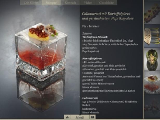 Ein kunstvoll angerichtetes Gericht mit Calamaretti und Kartoffelpüree in einem Glaswürfel.