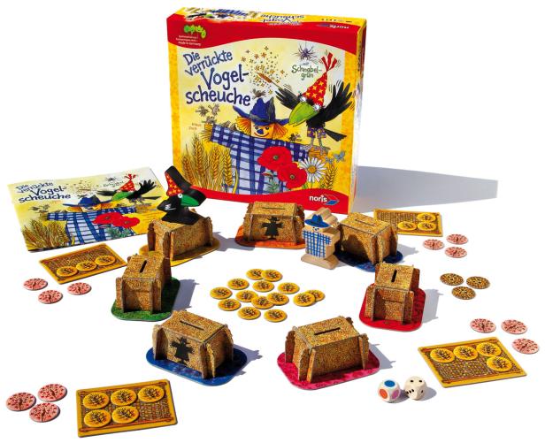 Das Spiel „Die verrückte Vogelscheuche“ von Noris mit Spielmaterialien und Würfeln.