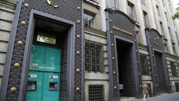 Die Fassade einer BNP Paribas Filiale mit kunstvollen Verzierungen und einem Geldautomaten.